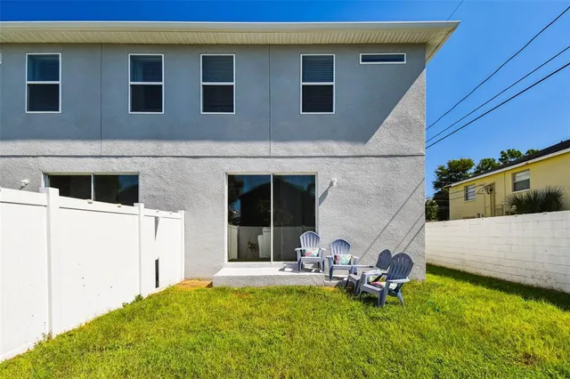 a view of a house with backyard sitting area and pool