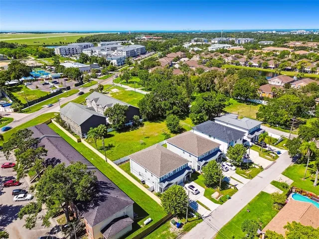 an aerial view of residential houses with outdoor space