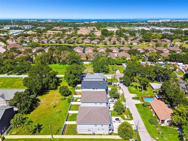 an aerial view of residential houses with outdoor space