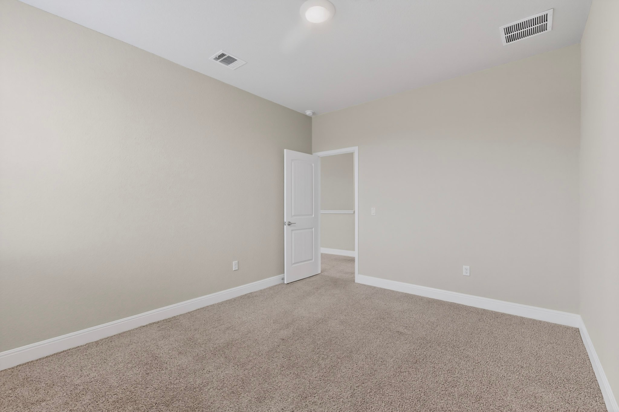 16809 Guido Cove Pflugerville, TX 78660 - Photo 28 of 40 Neutral-toned room featuring light beige walls and complementing carpet flooring