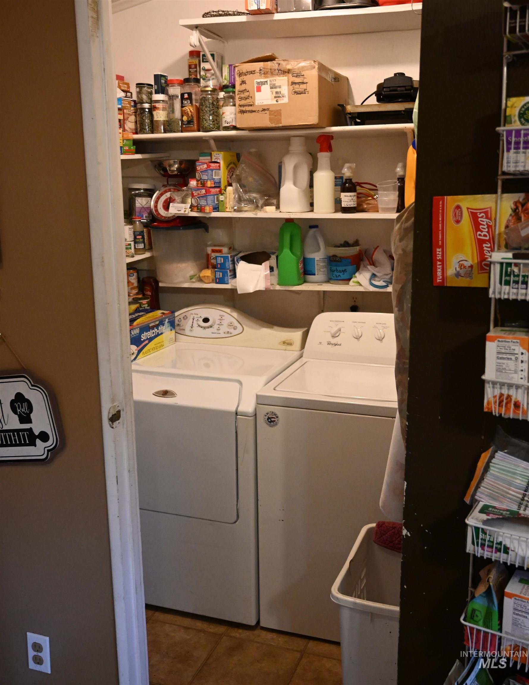 32288 Amos Bench Road Lenore, ID 83541 - Photo 21 of 24 Washroom with washer and clothes dryer and dark tile patterned floors