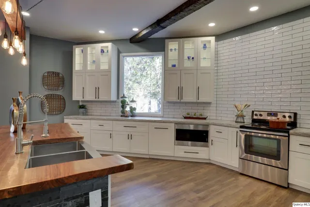 a kitchen with a stove a sink and a refrigerator