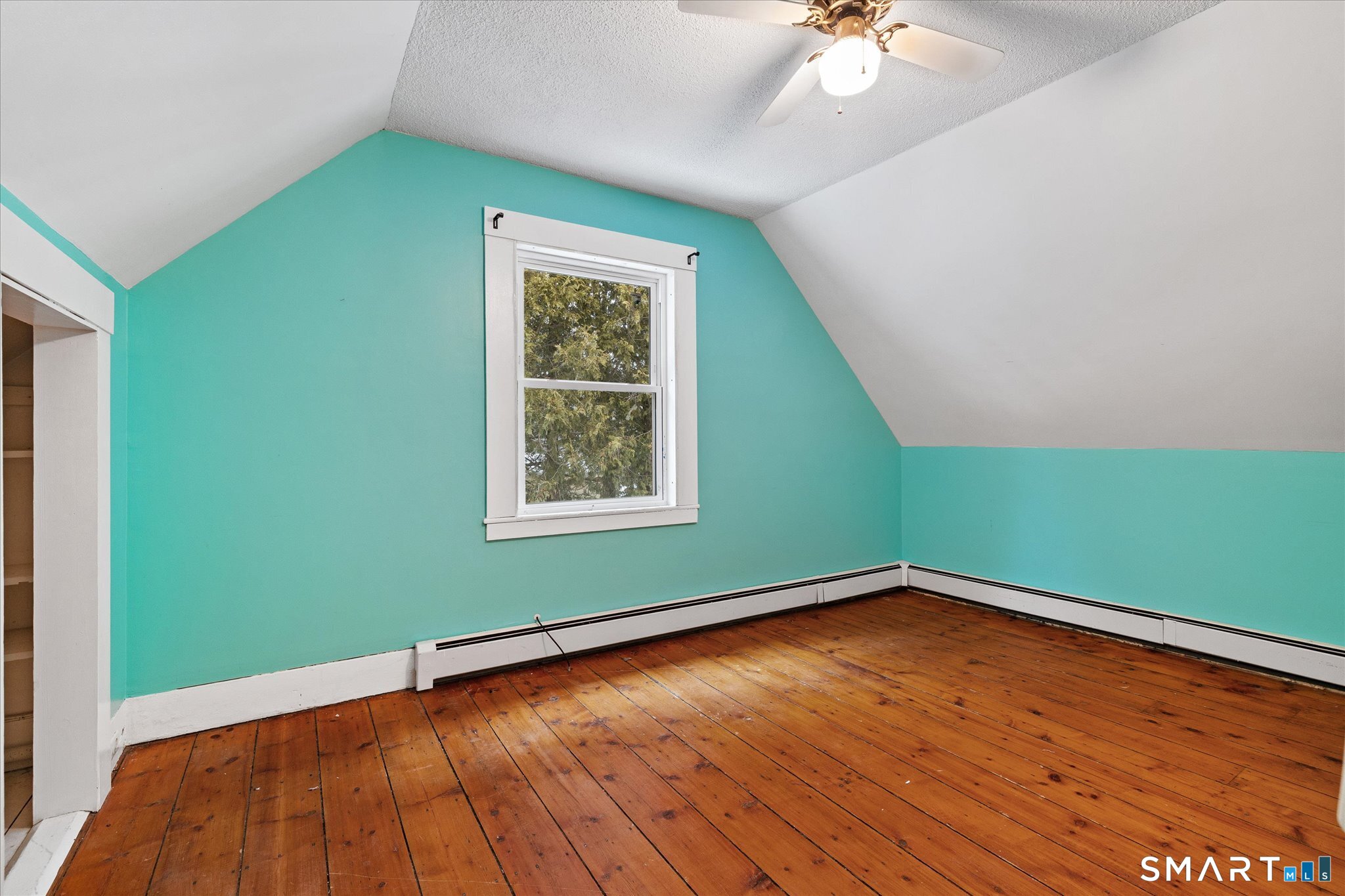119 Quercus Avenue Windham, CT 06226 - Photo 20 of 30 a view of a room with window a ceiling fan and wooden floor