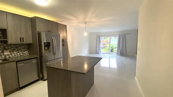a kitchen with refrigerator and window