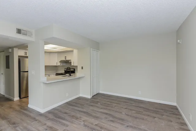 a kitchen with granite countertop a refrigerator and a sink