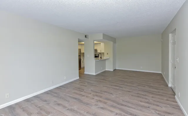a view of a kitchen with a sink and refrigerator