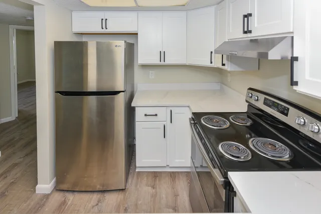 a kitchen with a refrigerator and a stove