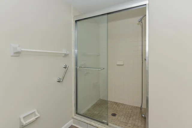 a bathroom with a glass shower door