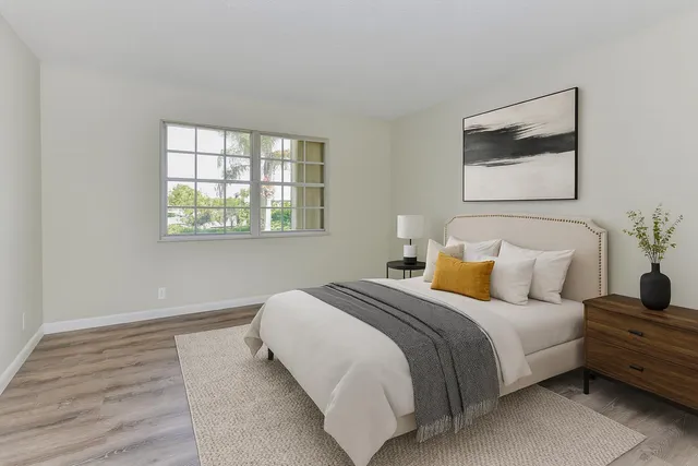 a bedroom with a bed and a window