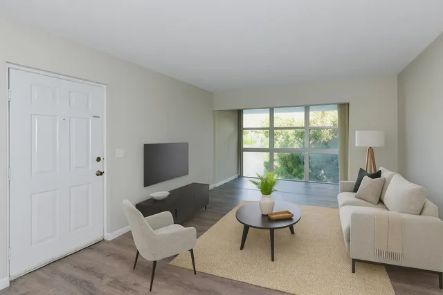 a living room with furniture and a large window