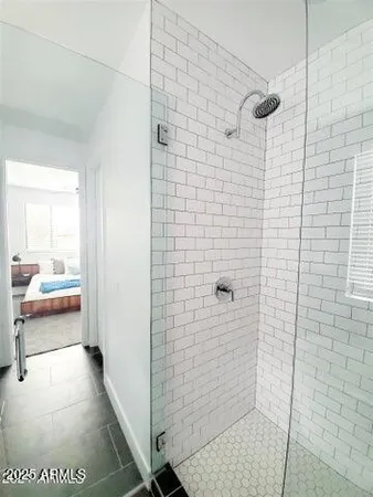 a bathroom with a shower and a sink