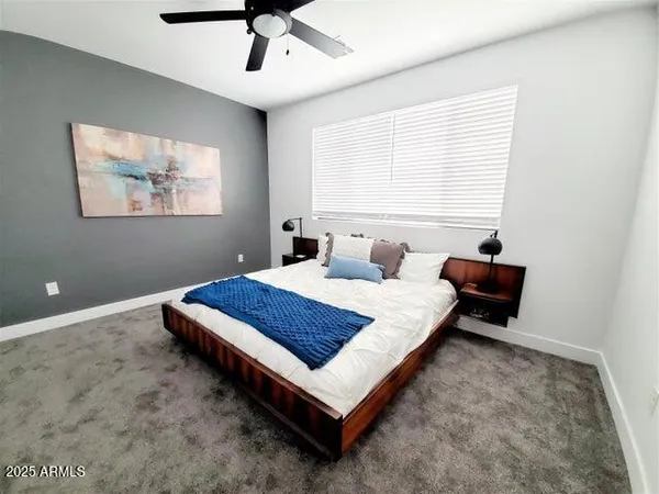 a bedroom with a bed and window