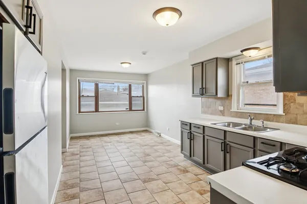 a kitchen with stainless steel appliances a refrigerator sink and cabinets