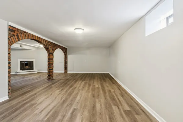 a view of an empty room and wooden floor