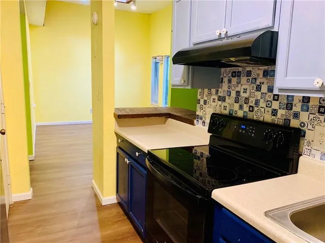 a kitchen with a sink and cabinets