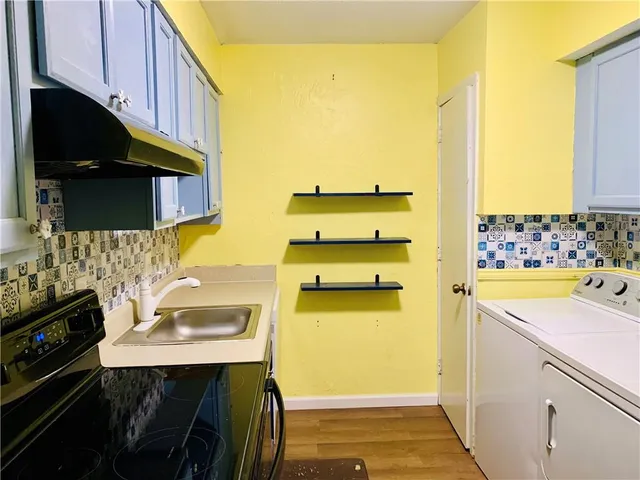 a kitchen with a sink and a stove