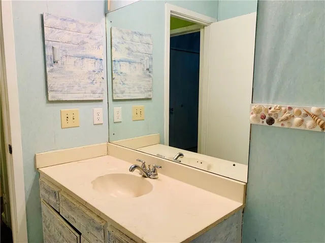 a bathroom with a sink and a mirror