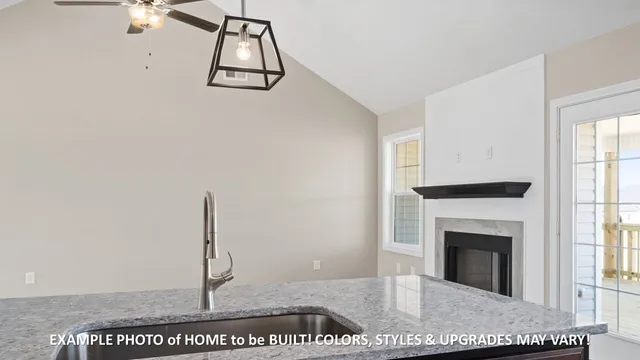 a view of a livingroom with a fireplace and window