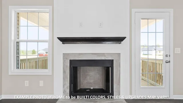 a view of an empty room with a window and fireplace