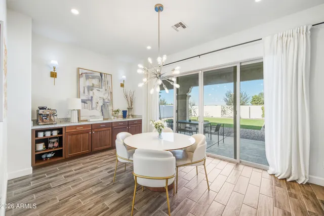 a dining room with furniture and wooden floor