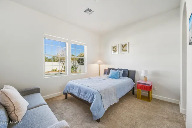 a bedroom with a bed couch and window