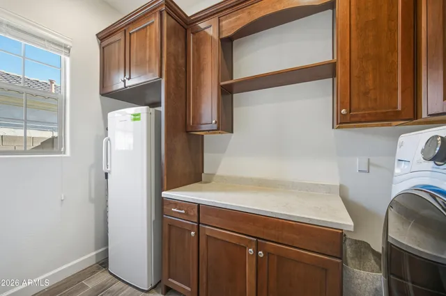 a kitchen with a refrigerator and cabinets
