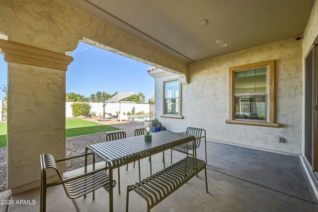 a view of a patio with a dining table and chairs