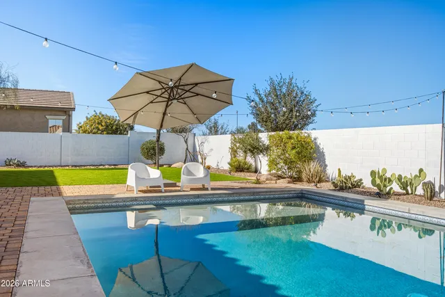 a view of swimming pool with a table and chairs