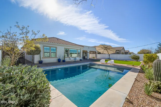 a view of a house with swimming pool and sitting area