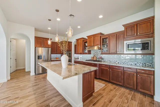 a kitchen with stainless steel appliances granite countertop a sink and cabinets