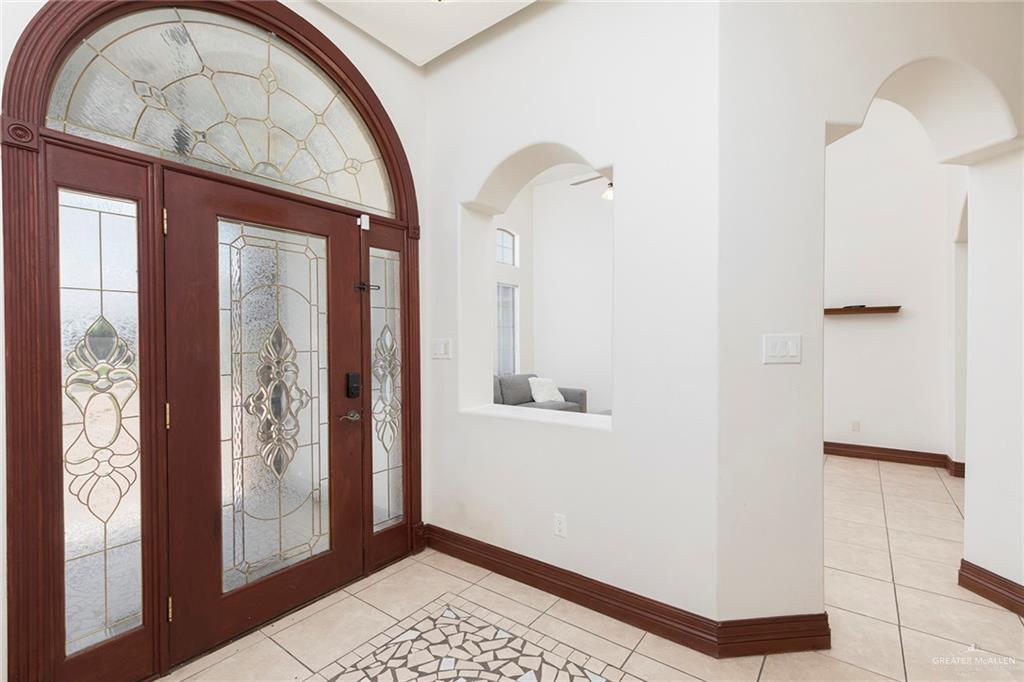 1213 Rhett Drive Pharr, TX 78577 - Photo 3 of 19 Elegant foyer with decorative glass double doors and soaring ceilings.