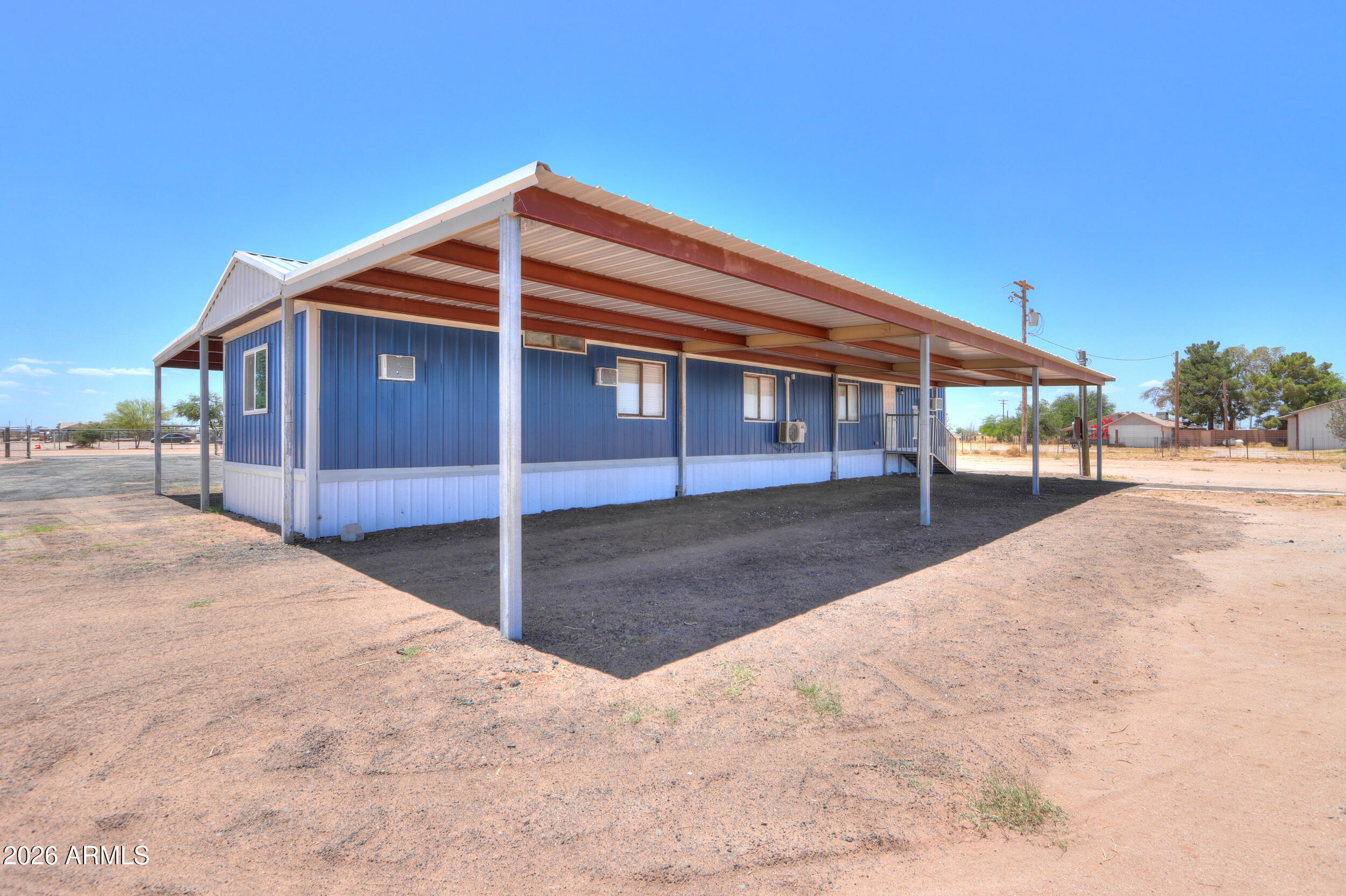 33776 West Siesta Road Stanfield, AZ 85172 - Photo 6 of 54 a view of a house with a snow in the yard