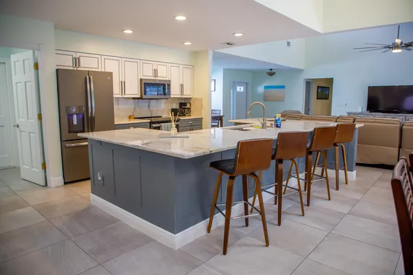 a large kitchen with a table and chairs