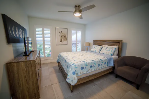 a bedroom with a bed a couch and dresser