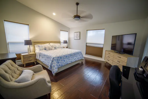a bedroom with a bed and a flat screen tv