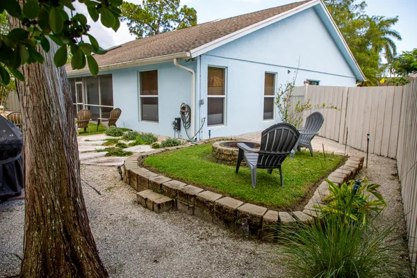 a front view of a house with garden and patio