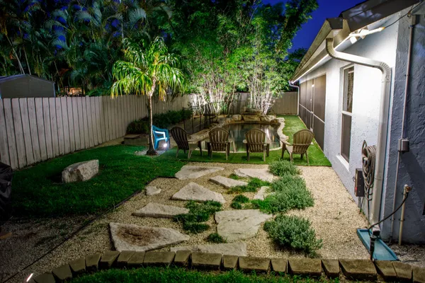 a view of backyard with wheel chair and potted plants