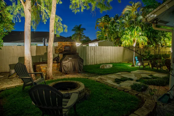 a backyard of a house with table and chairs