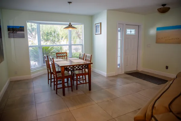 a dining room with furniture and window