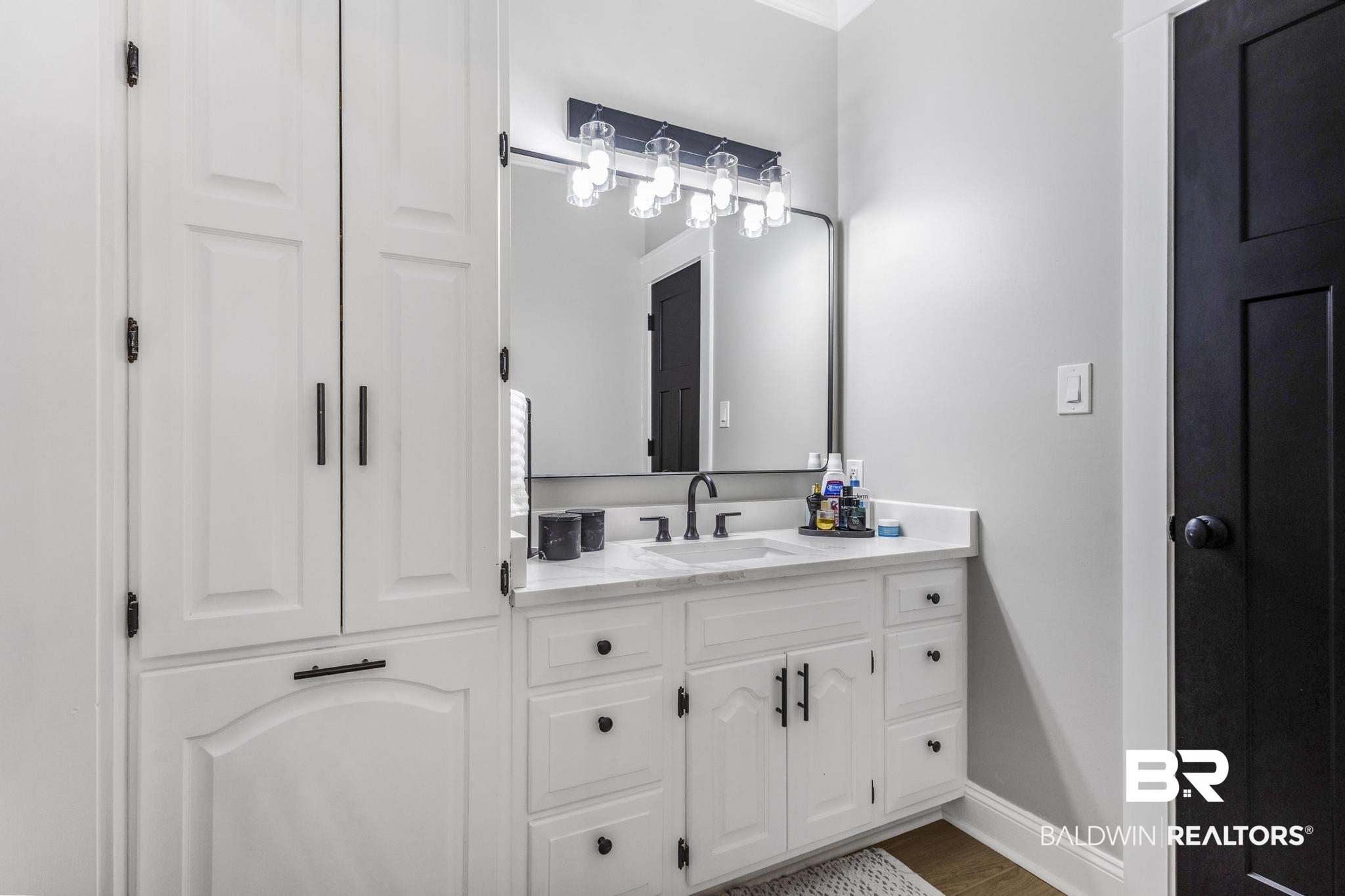83 Caisson Trace Daphne, AL 36527 - Photo 41 of 63 Bathroom featuring a white vanity with integrated sink, a rectangular mirror, and a five-light fixture