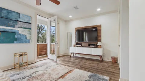a view of a balcony with wooden floor and fence