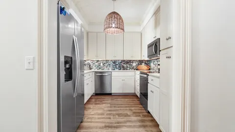 a utility room with cabinets washer and dryer