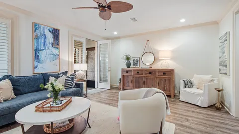 a living room with furniture a rug and a chandelier