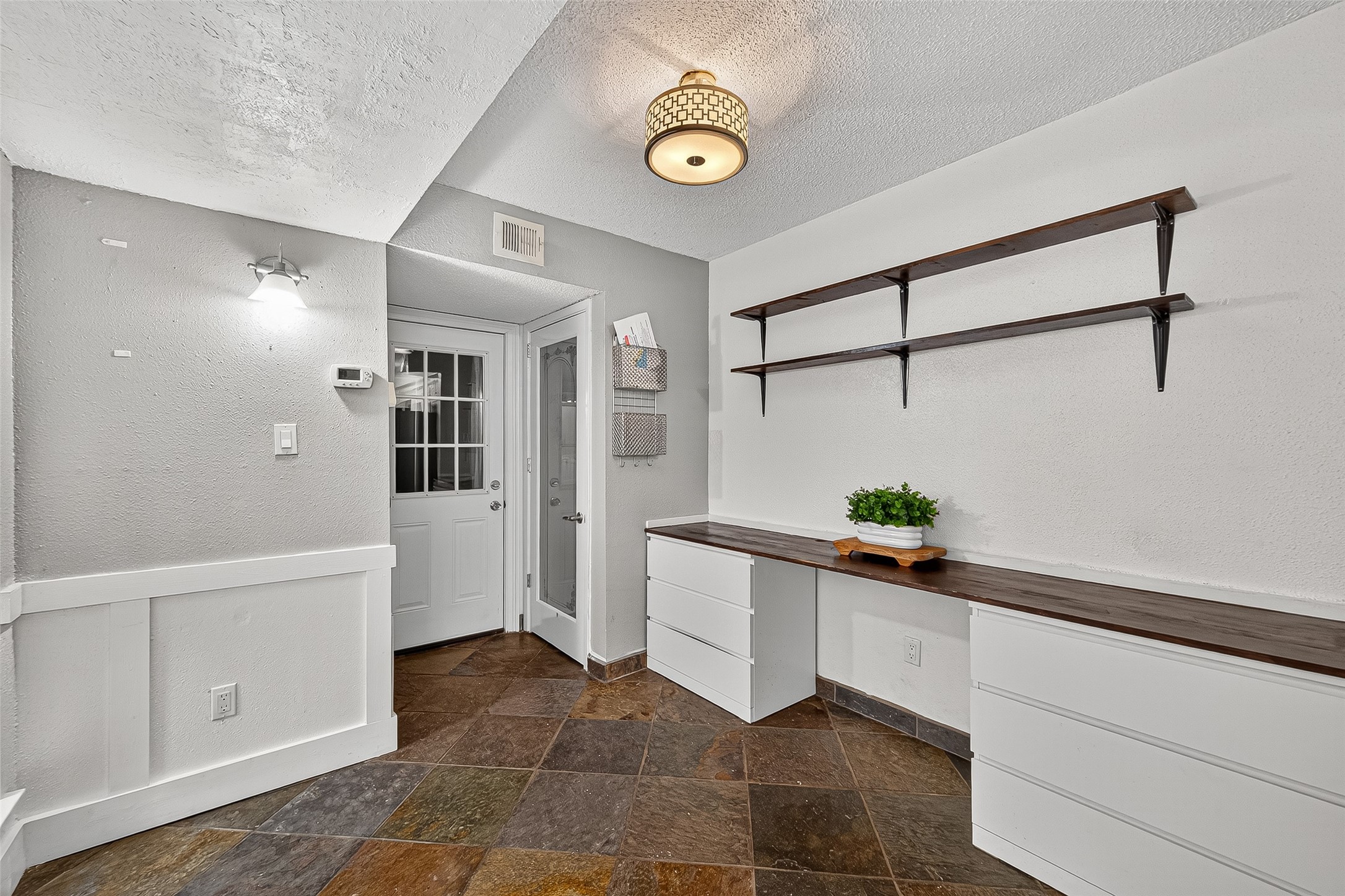 3200 South Gessner Road, Unit 224 Houston, TX 77063 - Photo 10 of 27 This home features a built-in desk with storage, perfect for a home office. Conveniently, the pantry is located next to the garage door.