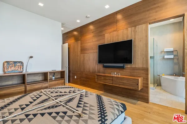 a living room with a flat screen tv and a rug