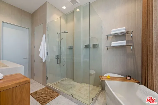 a bathroom with a tub and a shower
