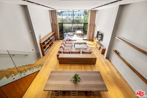 a view of a living room with furniture and a fireplace