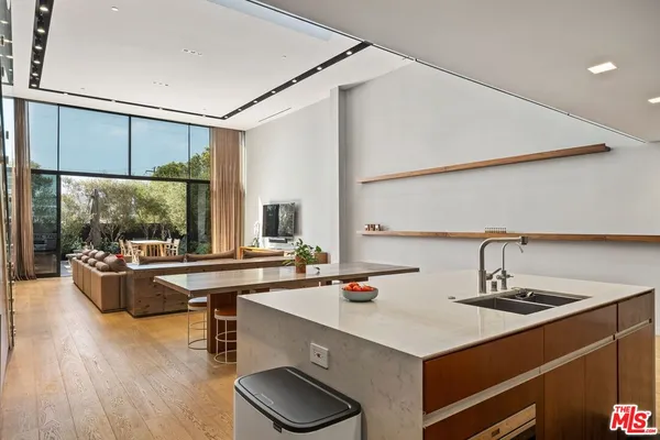 a kitchen with a sink and a stove top oven
