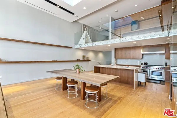 a dining room with a wooden table and chairs