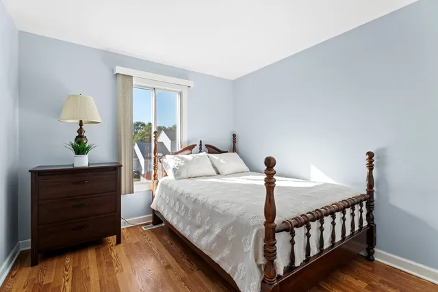 a bedroom with a bed window and a table